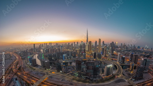 Canvas Print Panoramic skyline of Dubai with business bay and downtown district day to night timelapse