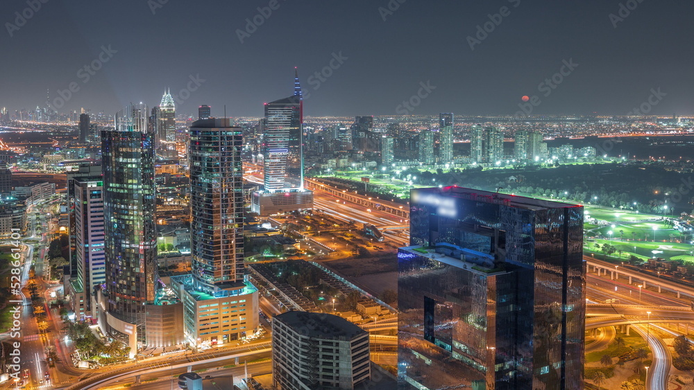 Moon rising over media city and al barsha heights district area night timelapse from Dubai marina.