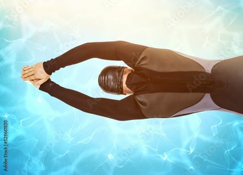 Rear view of swimmer diving into water