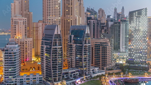 Dubai Marina skyscrapers and JBR district with luxury buildings and resorts aerial night to day timelapse © neiezhmakov
