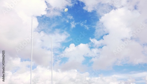 Rugby ball flying between posts