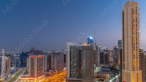 Skyscrapers at the Business Bay in Dubai aerial day to night timelapse  United Arab Emirates