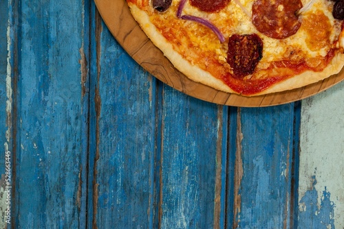 Pizza on blue wooden table