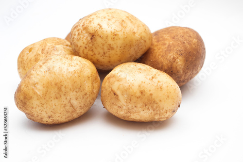 Fresh yellow raw potatoes on a white background