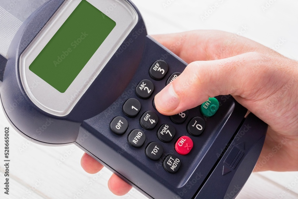 Cropped hand holding credit card reader