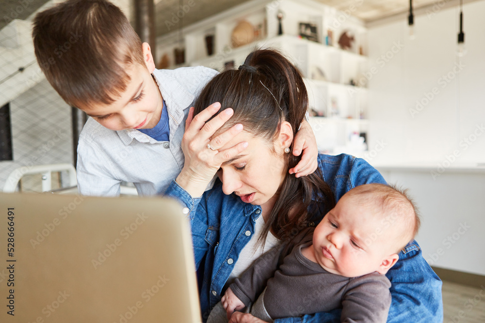 Stressed mother multitasking in home office Stressed mother multitasking in home office