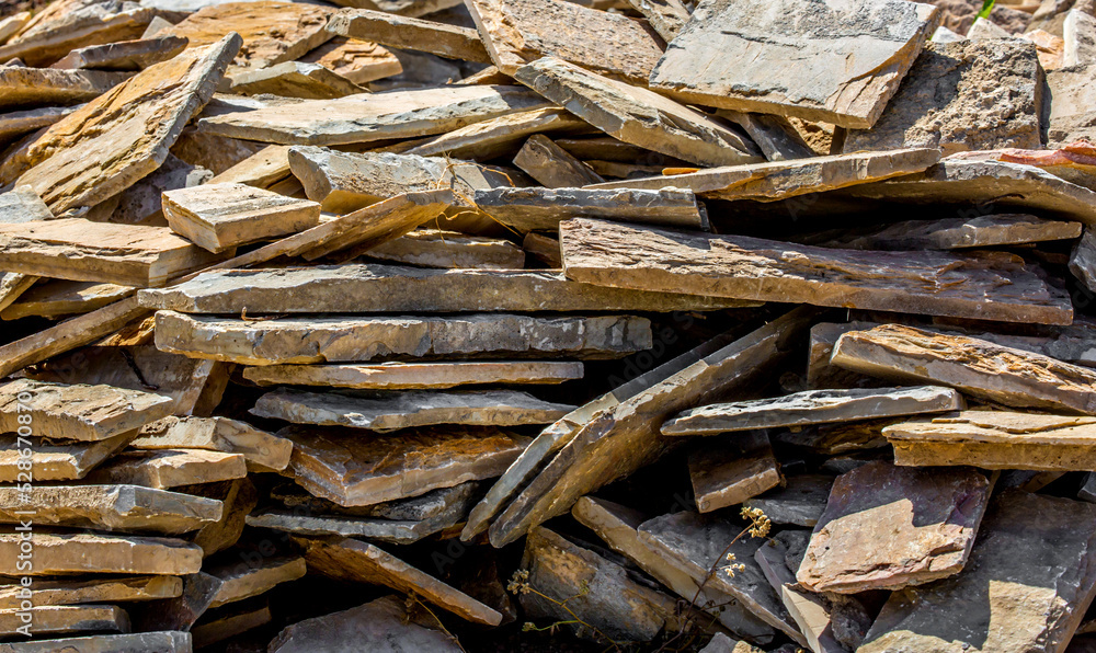 Firewood is split and stacked for the winter heating season. Background of stacked firewood, chopped wood for the stove.