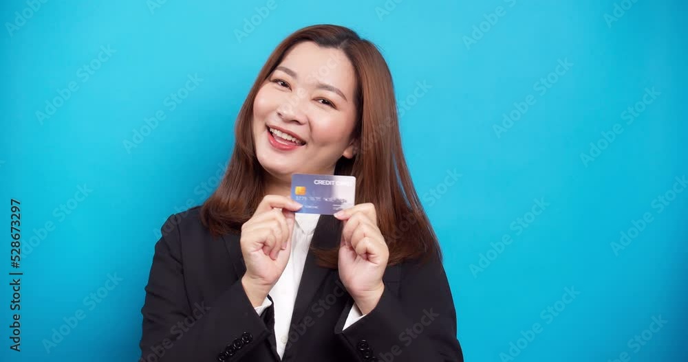 Portrait woman happy showing credit card for trendy shopping with cashless in the studio and copy space