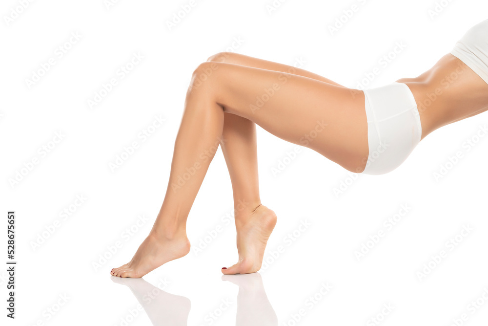 Side view of beautifully cared women's legs and feet on white background. Side view of beautifully cared women's legs and feet on white background.