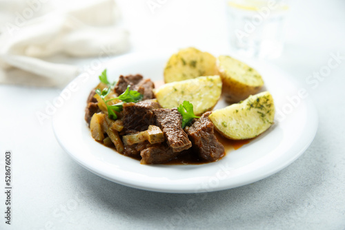 Homemade beef ragout with pickles and potato