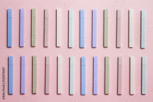 Colorful pens over the pink background. 