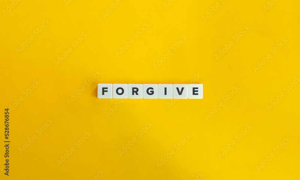 Forgive Word on Block Letter Tiles on Yellow Background. Minimal Aesthetics. Forgive Word on Block Letter Tiles on Yellow Background. Minimal Aesthetics.