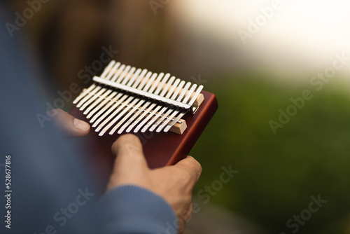 A man plays the kalimba. Kalimba in hands. Unique music. Portable musical instrument. Close-up of kalimba in hands.