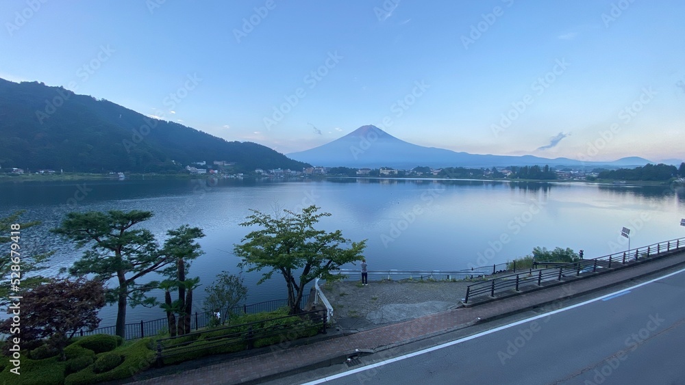 Magnificent Japanese traditional view, Mt Fuji at just after 5:30 am, the beautiful silhouette revealed in whole after cloudy evening the day before.  Photo taken year 2022 August 27th