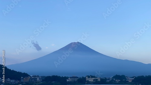 Magnificent Japanese traditional view, Mt Fuji at just after 5:30 am, the beautiful silhouette revealed in whole after cloudy evening the day before.  Photo taken year 2022 August 27th © KAYO SUGIUCHI