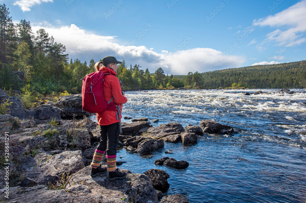 Woman hiking in forest in Finland Lapland