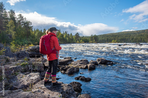 Woman hiking in forest in Finland Lapland