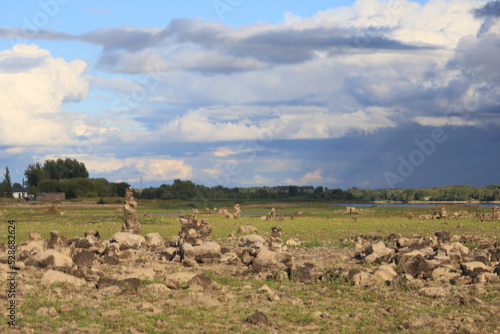 landscape of the drained river Daugava with stone pyramids