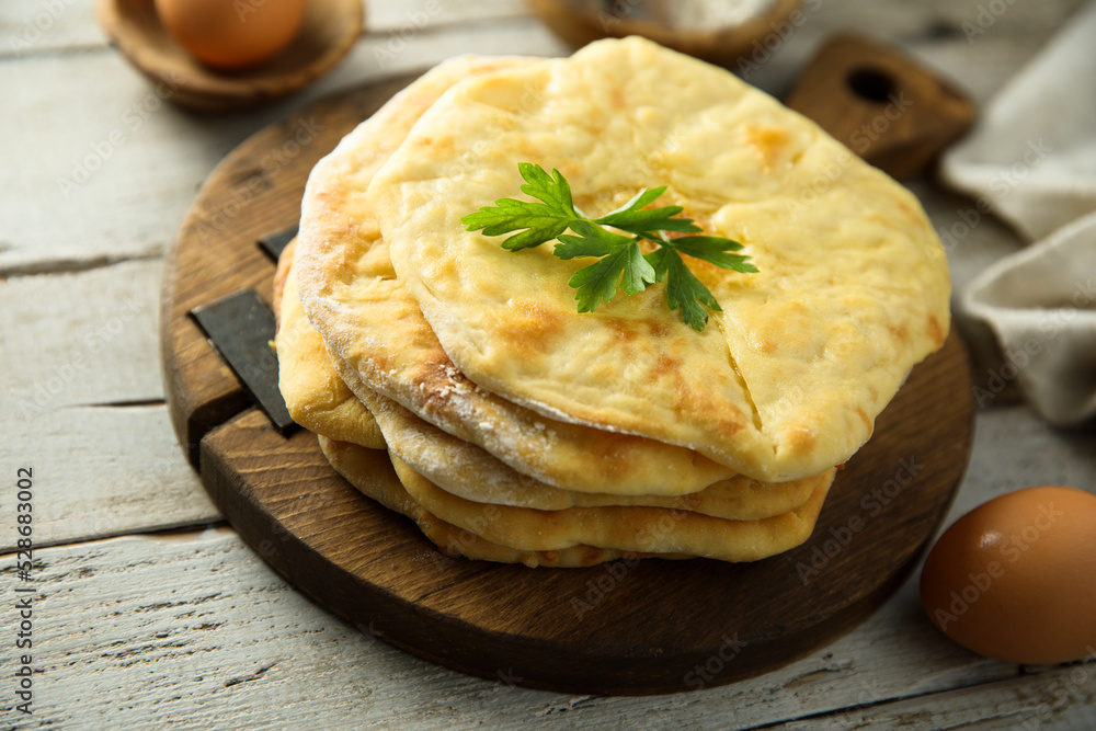 Traditional homemade flatbread on a wooden desk Traditional homemade flatbread on a wooden desk