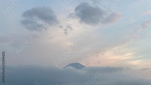 6pm  tip of Mt. Fuji   s head started to peak behind the thick clouds  showing us bless and saying hello after days of cloudy weeks.  We were lucky. Year 2022 August 26th  Yamanashi Kawaguchiko Lake.