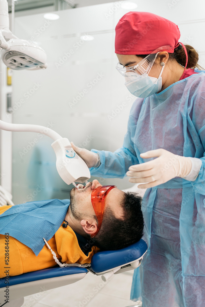 Man Doing Tooth Whitening Treatment Man Doing Tooth Whitening Treatment