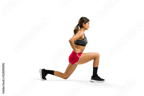 Young woman with a fitness lifestyle practicing leg lunges © AntonioDiaz