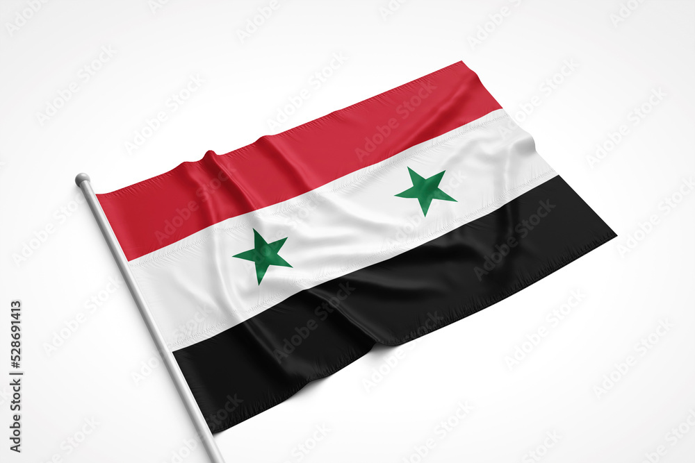 Naklejka premium Syrian Flag is Laying on a White Surface