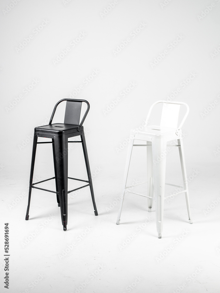 White and black bar chairs on white background