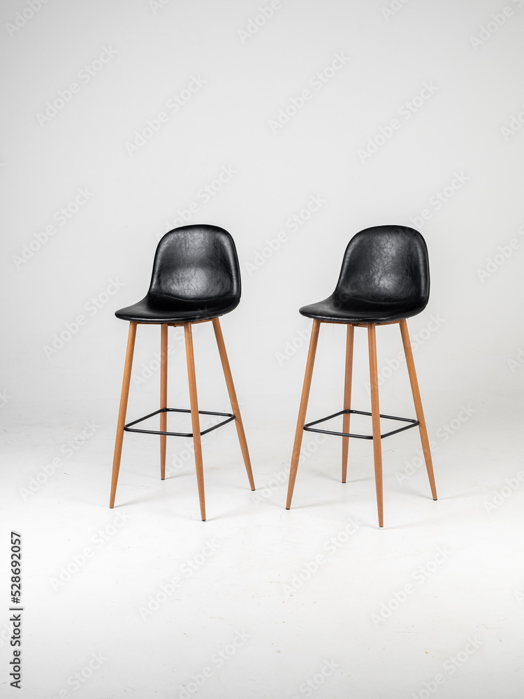 Black bar skin chairs with wood chair leg and black table on white background