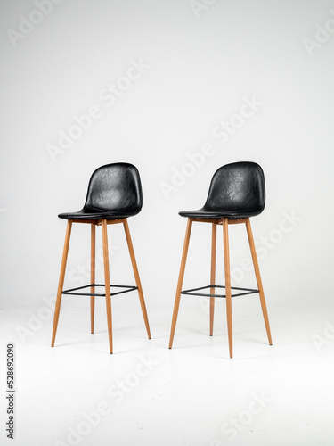 Obraz na płótnie Black bar skin chairs with wood chair leg and black table on white background w salonie