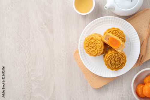 Delicious Cantonese moon cake for Mid-Autumn Festival food mooncake on wooden table background. photo