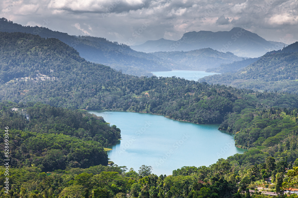 Magnificent lakes among the jungle of the island of Sri Lanka under thunderclouds