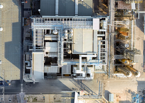 Bird's eye shot with drone, FIS chemical plant Gambellara (VI) Italy, September 05 2022 in the late afternoon. We see the production plants, liquid transport system and storage pipes, evaporative towe
