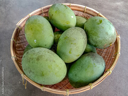 Kweni or mangifera odorata. Kweni fruit in a basket. photo