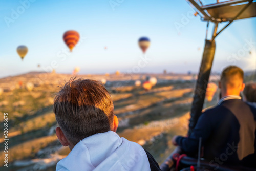 Teenager in hot air balloon watching Sunrise, hot air balloons during Sunrise