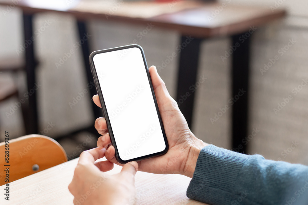 cell phone blank white screen mockup.hand holding texting using mobile on desk at office.background empty space for advertise.work people contact marketing business,technology cell phone blank white screen mockup.hand holding texting using mobile on desk at office.background empty space for advertise.work people contact marketing business,technology