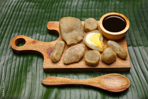 empek empek with cuka or vinegar sauce on a banana leaf background. empek empek is a traditional food from Palembang Indonesia. pempek palembang,
Indonesian dish photo