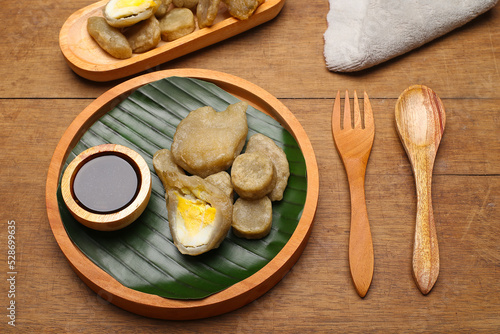 empek empek with cuka or vinegar sauce. empek empek is a traditional food from Palembang Indonesia. pempek palembang. Indonesian dish photo