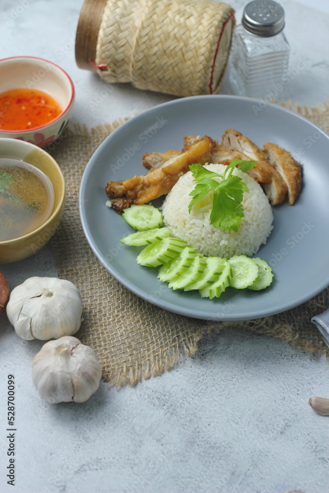 Hainanese chicken rice with fried chicken, fried chicken served with sweet dipping sauce and chicken broth, Asian style, street food commonly sold in Asia.