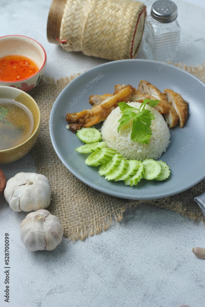 Hainanese chicken rice with fried chicken, fried chicken served with sweet dipping sauce and chicken broth, Asian style, street food commonly sold in Asia. Hainanese chicken rice with fried chicken, fried chicken served with sweet dipping sauce and chicken broth, Asian style, street food commonly sold in Asia.