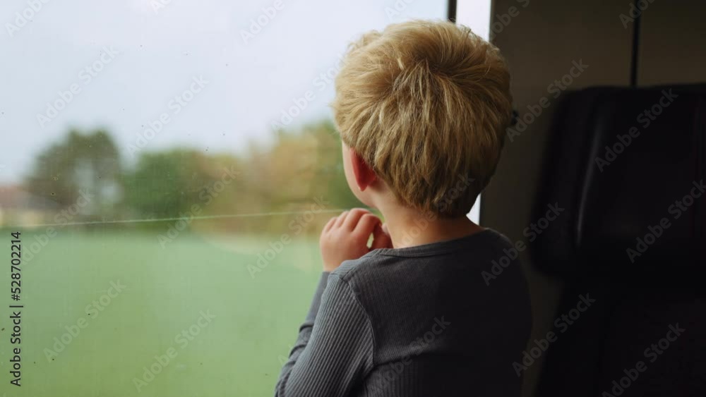 Young Boy Looking Out Of Train Window At The Passing Countryside Young Boy Looking Out Of Train Window At The Passing Countryside