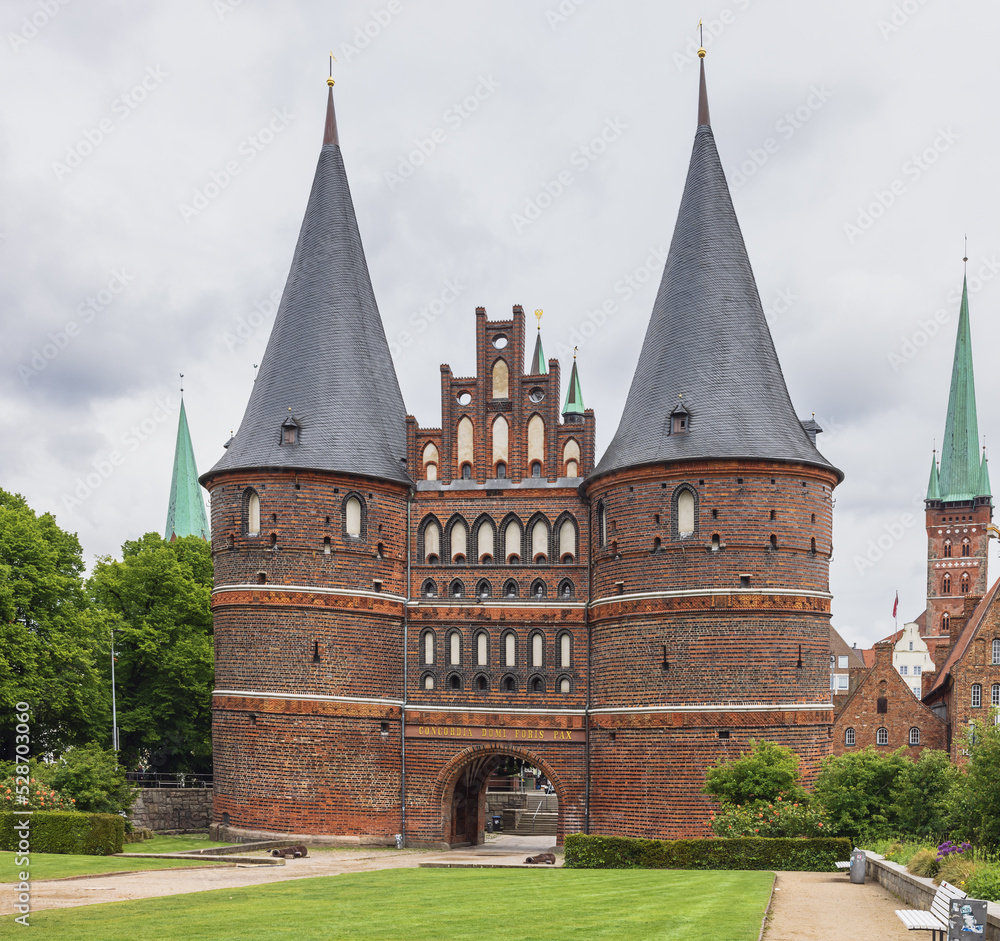 View of the Holsten gate at the entrance of the old town of Lubeck. Above the gate is written Harmony within, peace outside