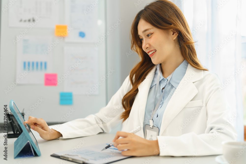 Successful business concept, Businesswoman reading financial report on tablet and taking note data Successful business concept, Businesswoman reading financial report on tablet and taking note data