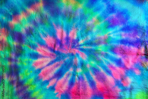Foto Swirl or Spiral pattern tie dye fabric in blue, green and magenta tones