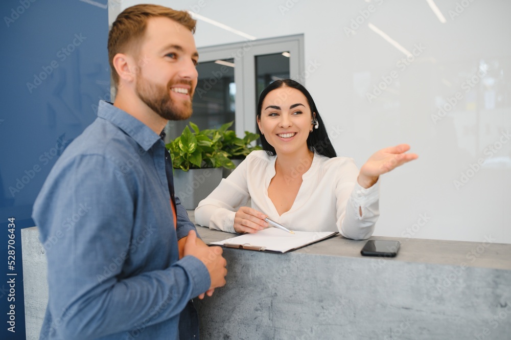 Excellent service. Nice friendly woman talking to the client while standing at the reception. Excellent service. Nice friendly woman talking to the client while standing at the reception.