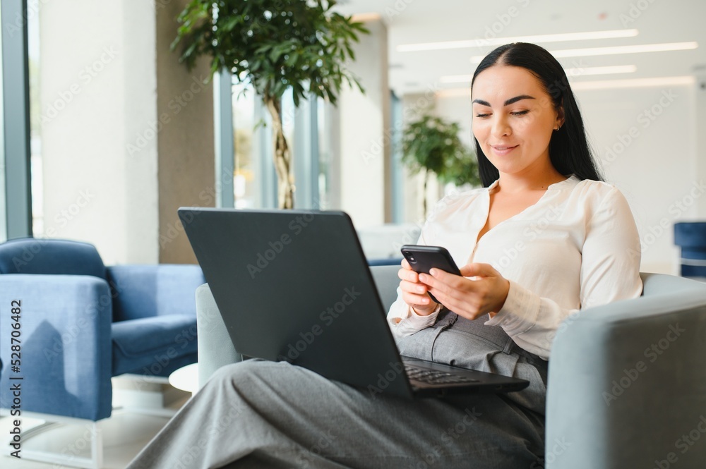 portrait of young attractive woman sitting in lecture hall, working on laptop, classroom, many yellow chairs, student learning, education online, freelancer, relaxed, hipster style. portrait of young attractive woman sitting in lecture hall, working on laptop, classroom, many yellow chairs, student learning, education online, freelancer, relaxed, hipster style.
