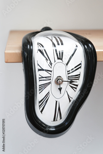 Decorative clocks drain off the shelf. The clock is a symbol of the impermanence of time. photo