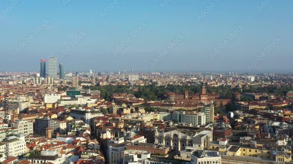 Milano from the drone in a sunny morning. Forward flight with historic Sforzesco castle view and Citylife district skyscrapers on the background. Milano from the drone in a sunny morning. Forward flight with historic Sforzesco castle view and Citylife district skyscrapers on the background.