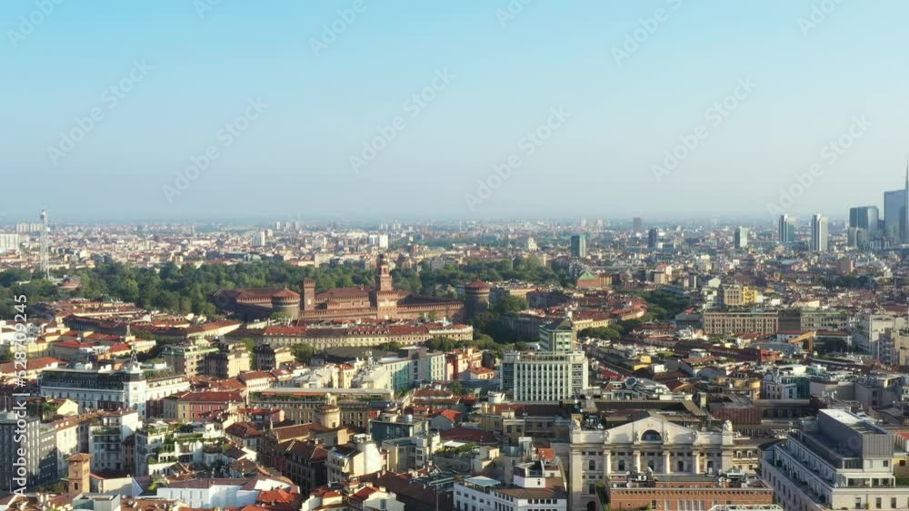 Milano from the drone in a sunny morning. Parallax flight with historic Sforzesco castle view and Porta Nuova skyscrapers district on the background. Milano from the drone in a sunny morning. Parallax flight with historic Sforzesco castle view and Porta Nuova skyscrapers district on the background.