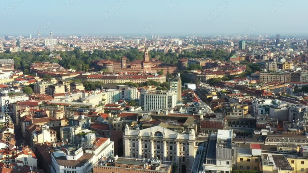 Milano from the drone in a sunny morning. Forward flight with Sforzesco castle view and camera down footage framing the local stock exchange historic building. Milano from the drone in a sunny morning. Forward flight with Sforzesco castle view and camera down footage framing the local stock exchange historic building.